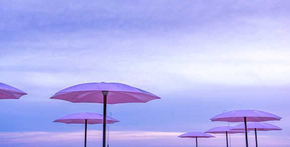 Downtown Toronto waterfront beach umbrellas at sugar beach during sunset in the summer.