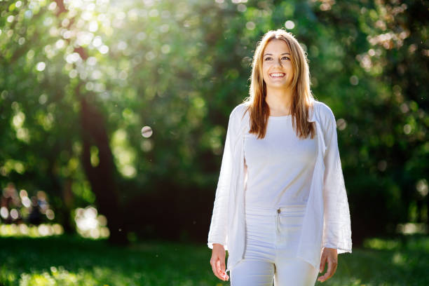 istock Beautiful brunette posing and smiling in nature 670434106