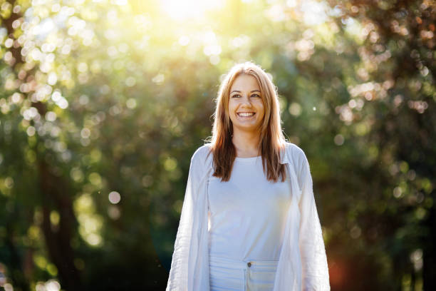 istock Beautiful brunette posing and smiling in nature 670434210
