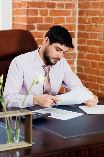 istock A young man sits at a desk in the office. 670440252