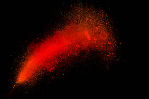 Freeze motion of colorful powder exploding isolated on black, Freeze motion of colorful powder exploding isolated on black background. Abstract design of dust cloud. Particles explosion screen saver wallpaper with copy space. Vivid red ash. Holi festival concept photoshop texture stock pictures, royalty-free photos & images