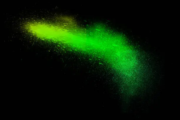 Photo of Freeze motion of colorful powder exploding isolated on black,