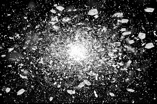 Freeze motion of  white powder exploding, isolated on black,