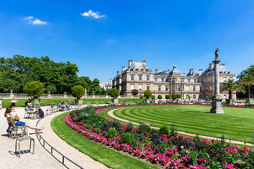 Paris, France - Jule 07, 2016: People enjoy sunny day in the Luxembourg Gardens in Paris. Luxembourg Palace is the official residence of the French Senate.