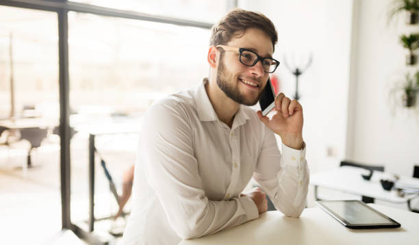 istock Businessman holding mobile device in cafe on business break 670442052