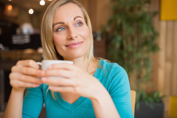 istock Thoughtful young woman holding coffee cup 670442776