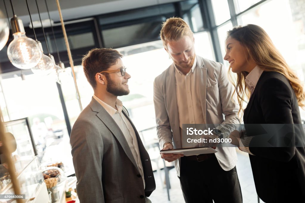 Happy business colleagues meeting at cafe smiling Networking Stock Photo