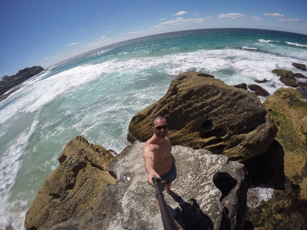 istock Young Man taking a selfie in a beach, Sydney, Australia 670445598
