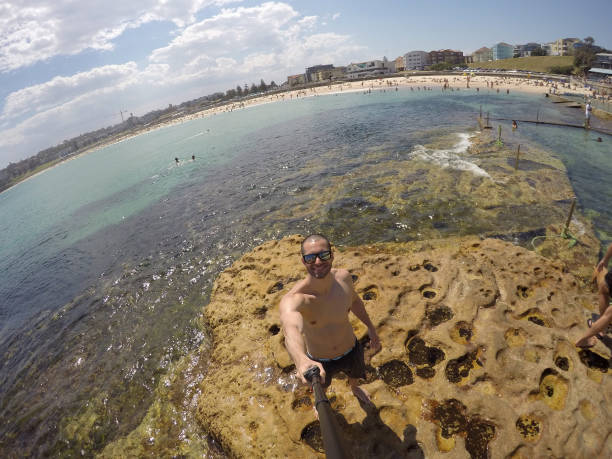 istock Young Man taking a selfie in a beach, Sydney, Australia 670445690