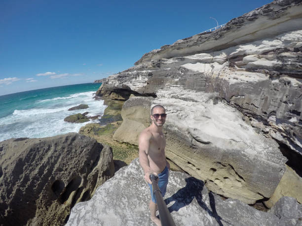 istock Young Man taking a selfie in a beach, Sydney, Australia 670446036