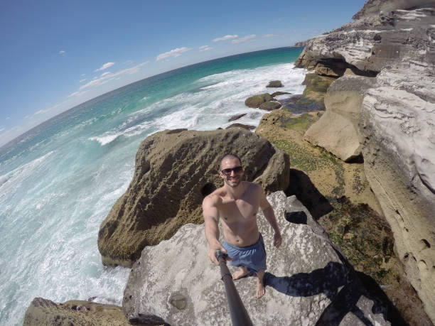 istock Young Man taking a selfie in a beach, Sydney, Australia 670447192