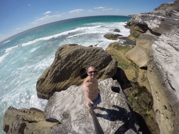 istock Young Man taking a selfie in a beach, Sydney, Australia 670447364