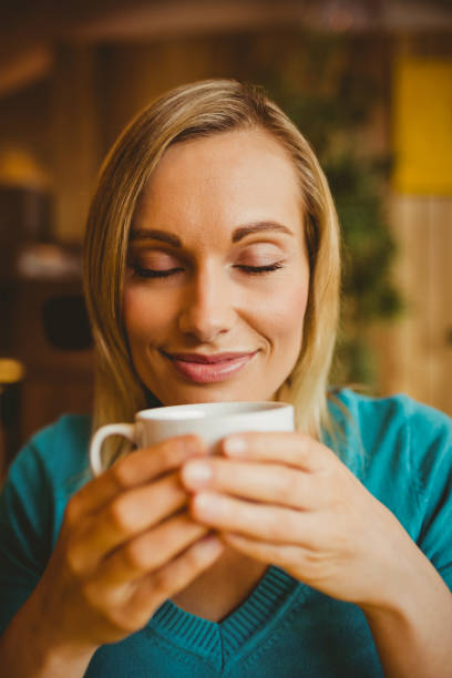 istock Young woman holding coffee cup 670447874