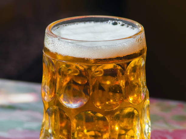 istock glass of fresh lager beer on table closeup 670448248