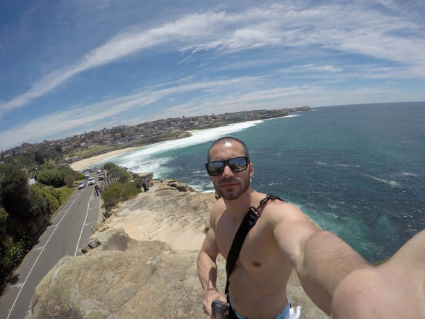 istock Man taking a selfie in Manly Beach, Sydney, Australia 670448516