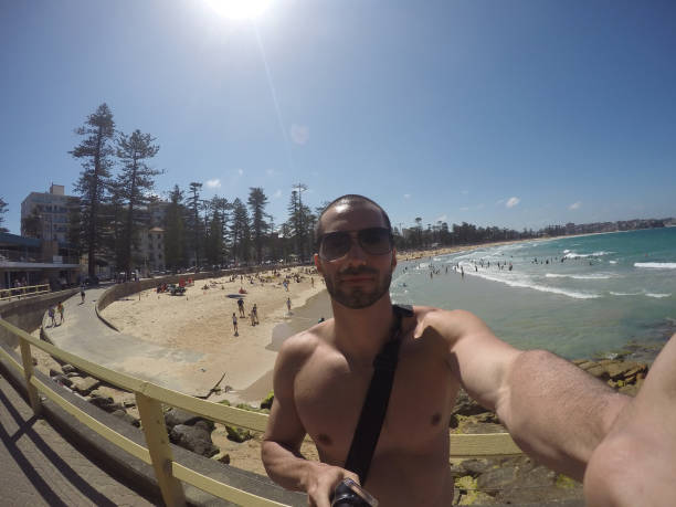 istock Man taking a selfie in Manly Beach, Sydney, Australia 670448526