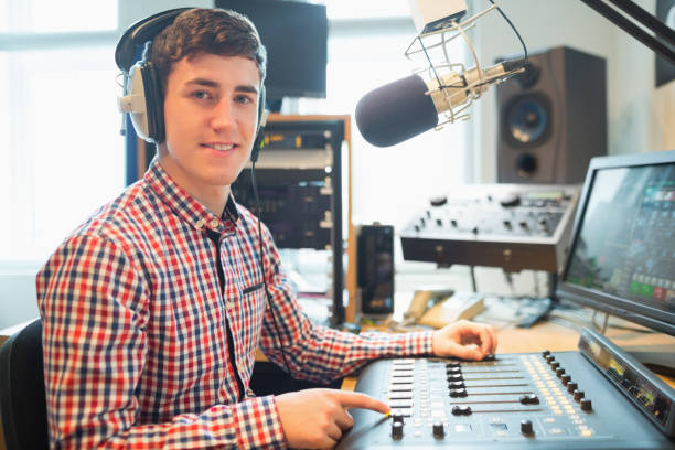 istock Portrait of radio host using sound mixer 670448940
