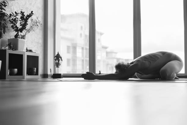 istock Peaceful female yogi exercising in apartment 670449600