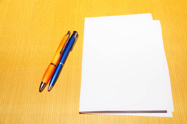istock Pen and blank paper on desk 670450066
