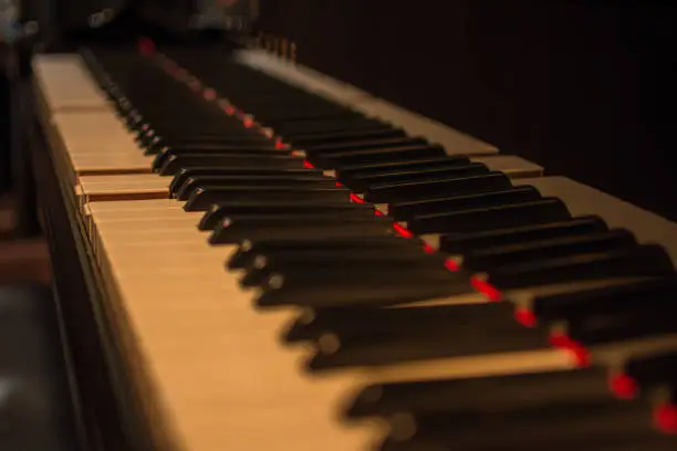 Piano keys on black classical grand piano play a classic song