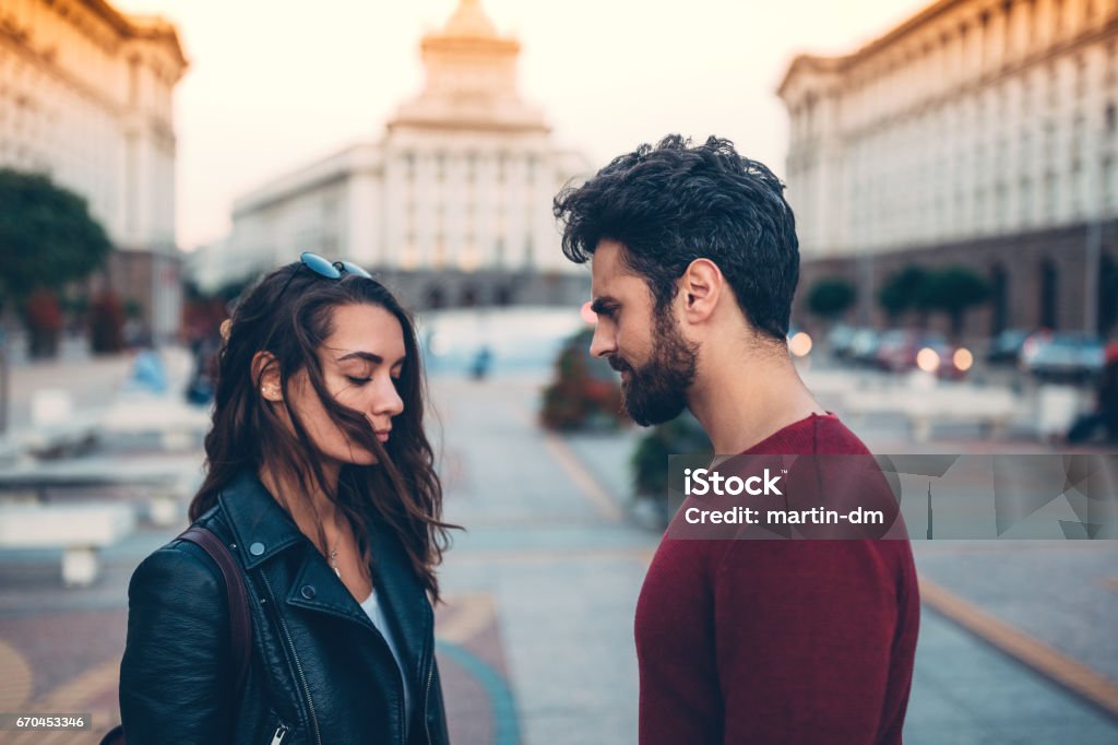 Young couple breaking up Man and woman arguing at the street Couple - Relationship Stock Photo