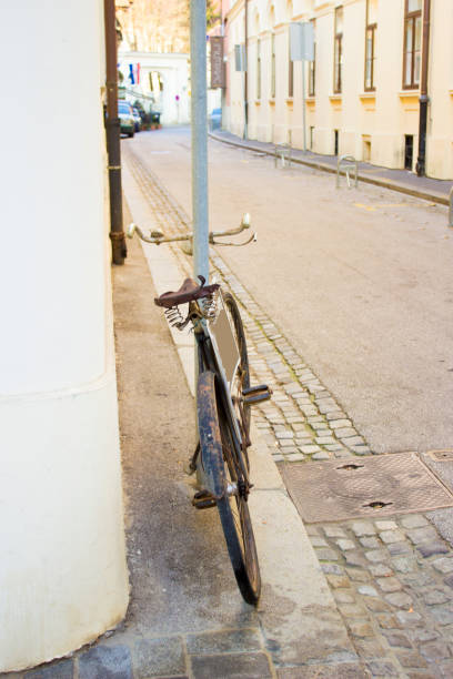 istock Retro style bike locked on the pole 670456436