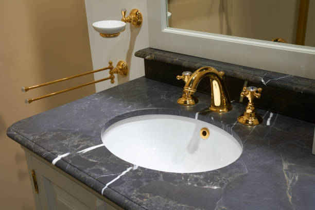 istock Sink and gold mixer 670460316