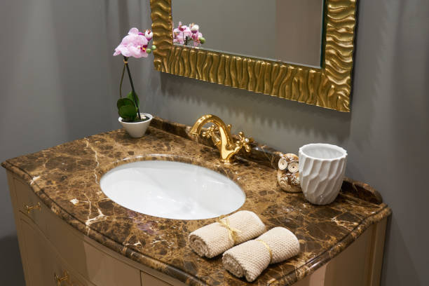 istock Sink and gold mixer 670460354