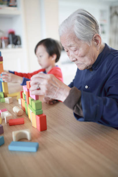 istock Grandson and grandma playing with blocks 670467444