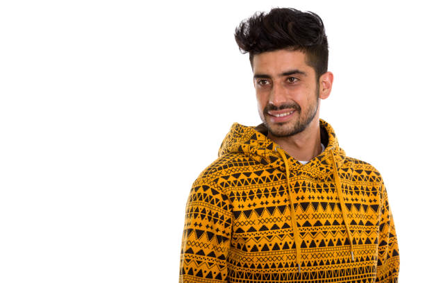 istock Studio shot of young happy Persian man smiling while thinking and looking at distance 670468220