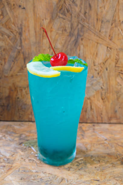 istock Blue Lime Soda on a wooden table background 670471208