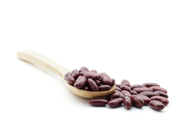 istock Red beans on wooden spoon isolated white background. 670471964