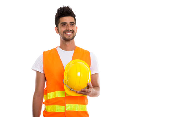 istock Thoughtful happy Persian man construction worker smiling while holding hard hat 670472280