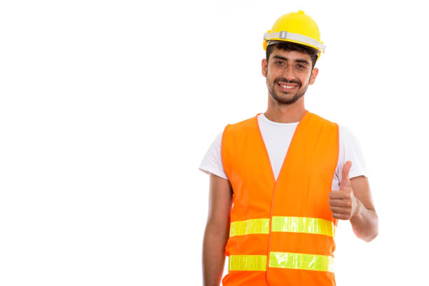istock Young happy Persian man construction worker smiling while giving thumb up 670472366