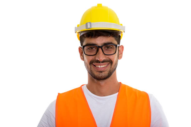 istock Studio shot of young happy Persian man construction worker smiling while wearing eyeglasses 670472538