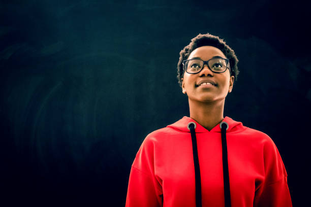 istock Young girl posing in front of blackboard 670477090