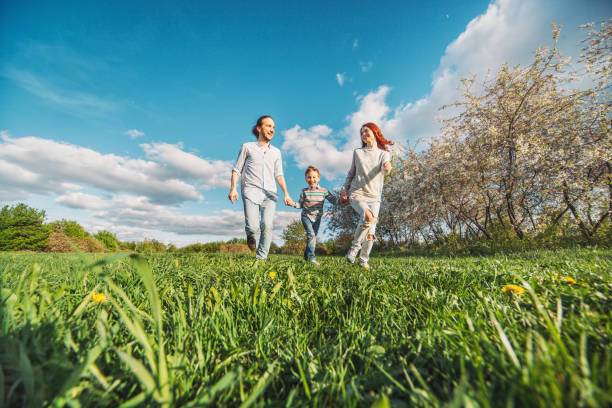 istock Happy family running in the park 670481290