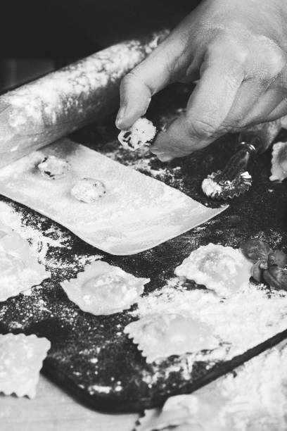 making ravioli, cutting the dough, stuffing the italian pasta