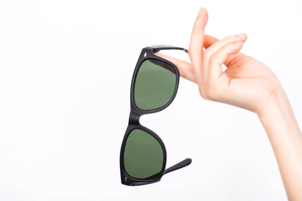 istock Hand holding pair of sunglasses on white background. 670494778