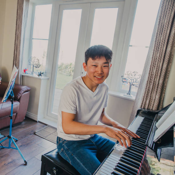 istock Chinese Boy Playing the Grand Piano! 670495050