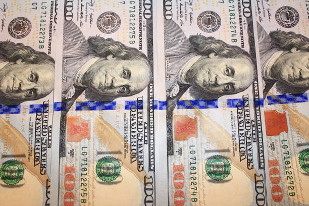 istock cash in new hundred dollar bank notes 670495106