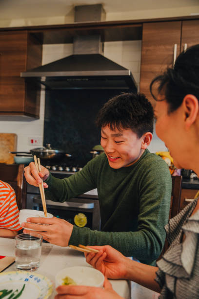 istock Chinese Teen Eating at Dining Table! 670495996