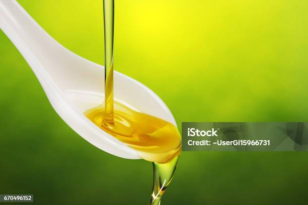 Extra Virgin Olive Oil Poured In A Spoon Stock Photo - Download Image Now - Olive Oil, Purity, Overflowing