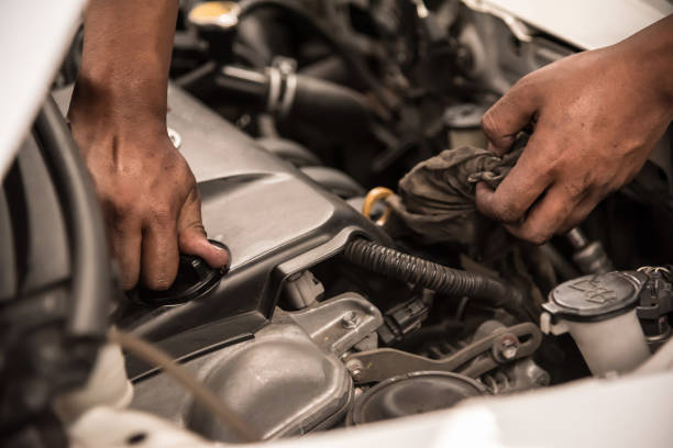 istock Close up Mechanic hands holding on engine cap after change new engine oil. 670505498