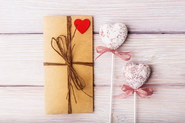 istock Love letter and decorative hearts on wooden background 670509268