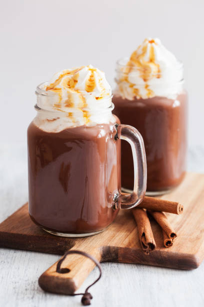 hot chocolate with whipped cream caramel in mason jar - norway maple imagens e fotografias de stock