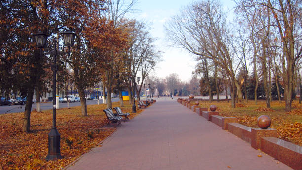 istock benches and path in the Autumn city park with trees 670514082