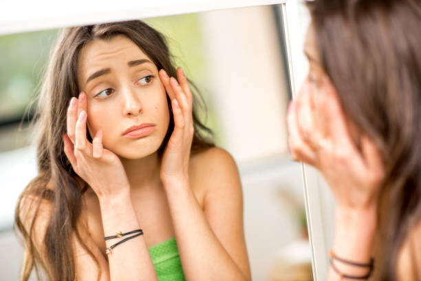 istock Woman looking at mirror in the bathroom 670514234