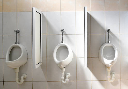 White, clean men toilet in a row