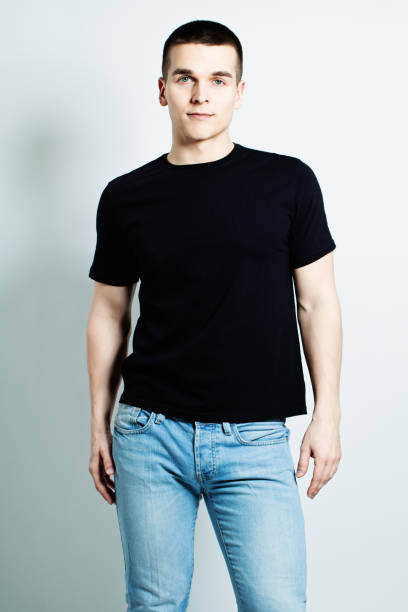 istock Guy Wearing Black T-Shirt and Blue Jeans 670524328